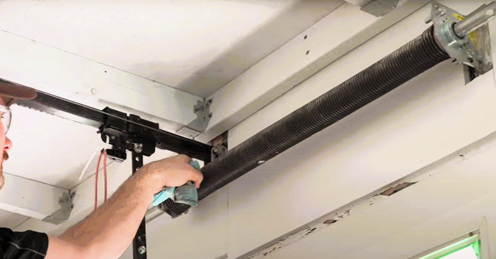 echnician performing garage door spring repair in Bradenton, Florida for a residential home
