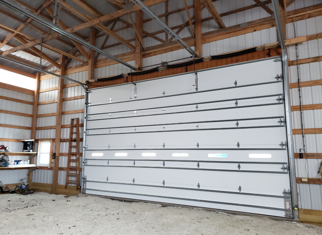 Technician performing commercial garage door repair in Bradenton, Florida, ensuring smooth operation and functionality